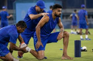 Generic fast bowler works with physios during an IPL training session before a key match.