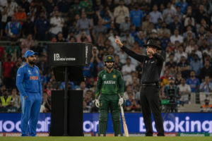 Generic cricket umpire reviews a decision using modern technology during an international match.