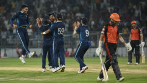 Generic T20 fielders celebrate under lights after a batting collapse in Ahmedabad