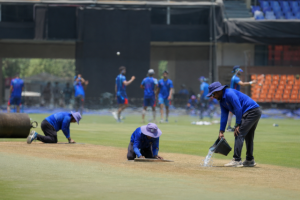 Ground staff prepare an IPL venue as the BCCI considers changes to avoid extreme summer conditions.