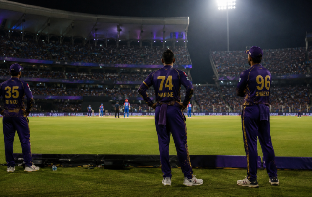 IPL players watch scoreboard updates during a playoff race match affected by net run rate calculations.