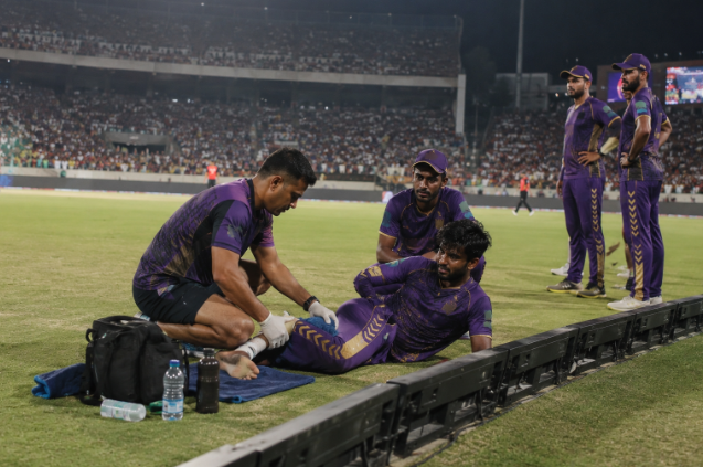A Kolkata Knight Riders bowler receives treatment during a crucial IPL 2026 playoff race match.