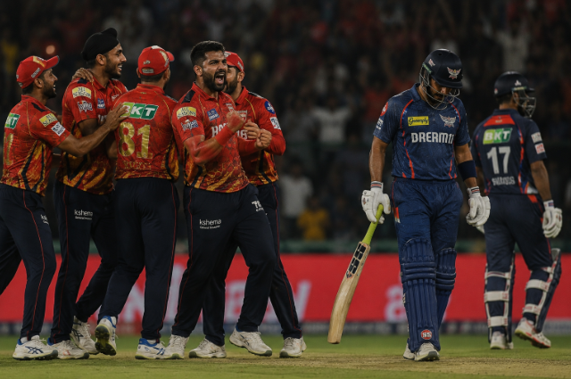 Punjab Kings-style players celebrate during a key IPL 2026 playoff race match.
