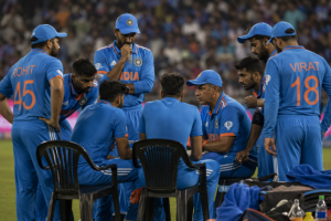 Cricketers discuss tactics during a match as player roles influence betting analysis.