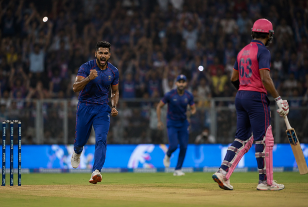 Generic fast bowler celebrates after taking a wicket during Rajasthan Royals’ IPL playoff-clinching victory.
