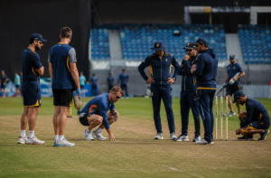 Players and coaches inspect a cricket pitch before the ODI World Cup as discussions around playing conditions continue.
